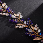 Head jewelry with blue beads and gold-colored leaves